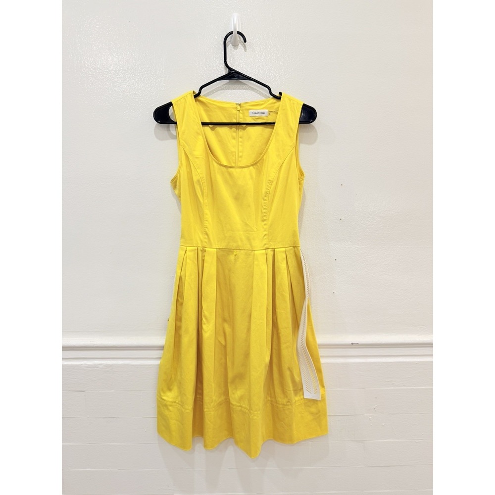 Calvin Klein sleeveless fit-and-flare dress in a cheerful sunshine yellow.‎